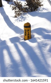 Marker For Natural Gas Pipeline Partly Buried In Snow After Winter Storm.