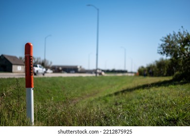 Marker Post For Underground Internet Optics Line Along A Road Ditch. 