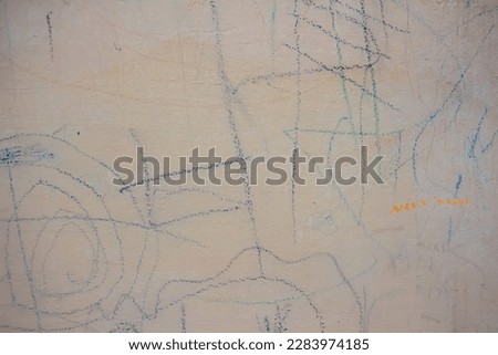 marker scribbles on a white wall