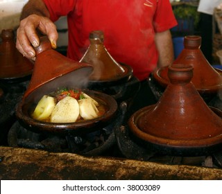 Market Cook Holding A Cover Of A Tajine Dish (traditional Casserole). His Hands Are Rather Dirty. Marrakech, Morocco