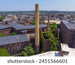 Market Mills with chimney aerial view next to Merrimack Canal at Lowell National Historical Park in historic downtown Lowell, Massachusetts MA, USA. 