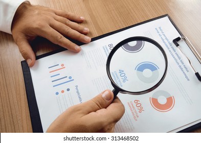 Market Research. Businessman Hand Holding Magnifier And Closer Study Report From Market Research. Concept For Website Banner, Background, Presentation Template And Marketing Materials.
