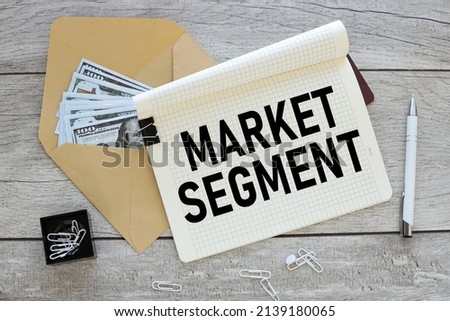 MARKET SEGMENT. text on a notepad next to an envelope with money