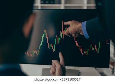 Market statistics and financial market graphs on laptop screens, financial analysts and day traders working on computers with multi-screen workstations with real-time stocks.