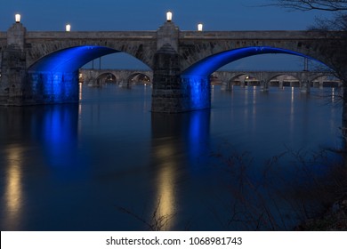 Market Street Bridge In Harrisburg PA At Dusk With Blue Lights Under The Bridge Reflecting On The River