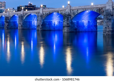 Market Street Bridge In Harrisburg PA At Dusk With Blue Lights Under The Bridge Reflecting On The River