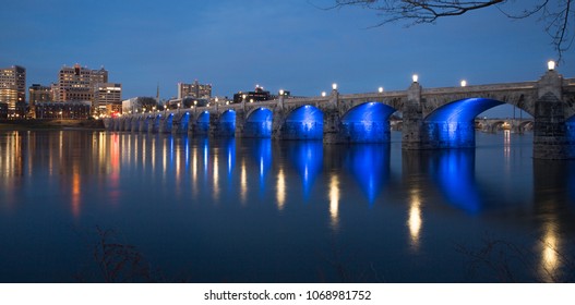 Market Street Bridge In Harrisburg PA At Dusk With Blue Lights Under The Bridge Reflecting On The River