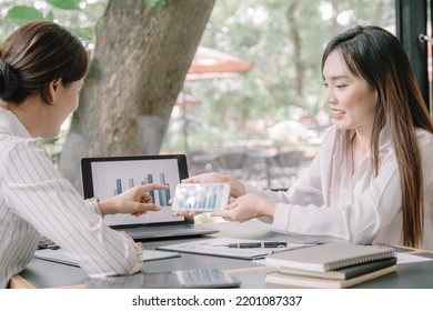 Marketer or analytic manager team dressed in suits working with paper charts and laptops at the meeting room.