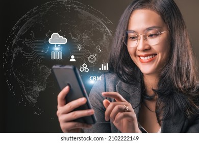 Marketer Leverage Big Data Processing To Analyze The Business. A Businesswomen In Suits Is Using Her Smartphone To View Customer Data Analysis And CRM, Technology For Business Development Concept.