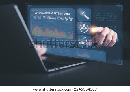 Marketer pointing to graph and showing SEO concept, optimization analysis tools, search engine rankings, social media sites based on results analysis data,Using keywords to rank on search pages