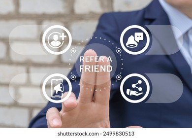 Marketer using virtual screen presses text: REFER A FRIEND. Referral marketing or affiliate marketing concept. Invite friends to refer a friend loyalty program to win online reward. Refer and earn.