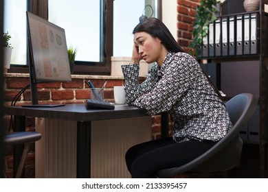 Marketing Agency Asian Employee Worried About Business Financial Problems And Poor Management Choices. Company Office Tired Worker Stressed By Looking At Failed Startup Project Statistics Numbers.