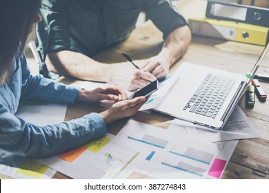 Marketing Analysis Team Meeting Concept. Young Businessman Crew Working With New Startup Project In Modern Loft. Generic Design Notebook On Wood Table. Horizontal, Film Effect