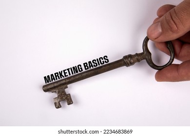 Marketing Basics concept. Knowledge and learning. Old key on a white background.