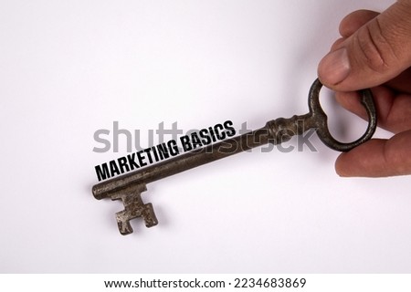 Marketing Basics concept. Knowledge and learning. Old key on a white background.