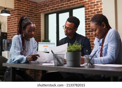 Marketing Company Financial Department Team Brainstorming Ideas To Be Used By Boardroom Executives. African American Team Reviewing Accounting Documentation Papers While In Office.