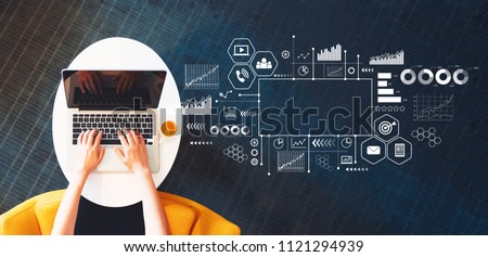 Marketing concept with person using a laptop on a white table