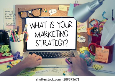 Marketing Strategy Concept / What is your marketing strategy note on laptop screen in office