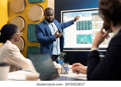 Marketing team sharing details on annual reports in enterprise meeting, providing initiatives to enhance operational success metrics. Group of business partners in a boardroom debate. - Powered by Shutterstock