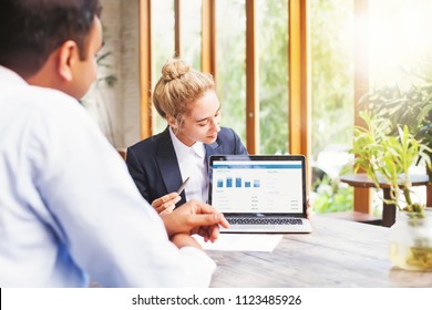 Marketing Team Working On A Presentation On Laptop