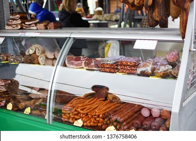 Marketplace Glass Display Case With Meat Deli. Various Meat Deli, Sausages, Hams, Steaks. Pork And Beef Products.