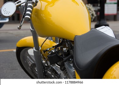 Markham, Ontario / Canada – September 9, 2018: A Vintage Yellow Motorcycle With Black Leather Seat And Chrome Rear View Mirror And Handle Bars, Parked On The Side Of A City Street.