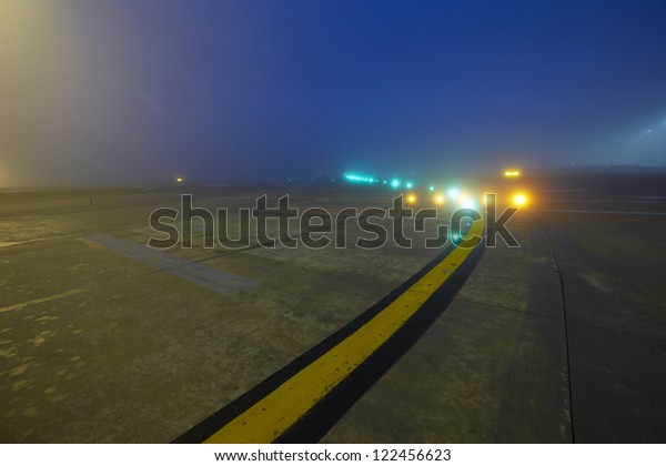 Marking on runway -\
Airport at the night