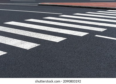 Markings of a pedestrian crossing on asphalt road. Roads infrastructure and transport