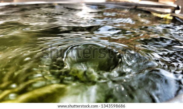 The marks of\
water droplets on the water in the basin Similar to the surface of\
the moon that was hit by a\
bat