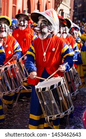 Marktplatz, Basel, Switzerland - March 13th, 2019. Close-up Of A Carnival Participant Disguised As An Old Lady Playing Snare Drum