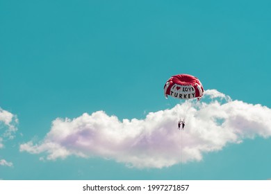 Marmaris, Mugla, Turkey: 06,09,2021 - Parasailing With I Love Turkey Slogan , A Couple Doing Watersports In Turkey , Blue Sky And Cloud Background