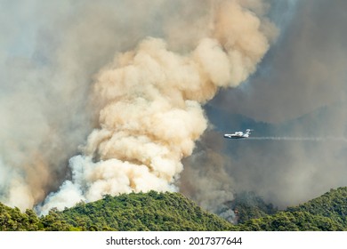 Marmaris, Mugla, Turkey – July 31, 2021. Smoke from a forest fire rising over Hisaronu neighbourhood of Marmaris resort town of Turkey on July 31, 2021. View with Russian Beriev Be-200 Altair aircraft