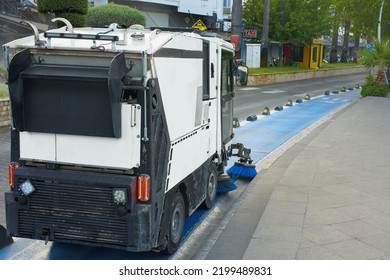 Marmaris, Turkey - August 10, 2022. A Small, Compact, Multifunctional Municipal Vacuum Utility Sweeper Sweeper With Blue Brushes Cleans The Bike Path. The Bike Path. Street Cleaning.