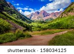 Maroon Bells in day light with clouds