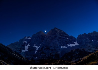 Maroon Bells Lake View In Aspen, Colorado At Dark Night With Rocky Mountain Peak And Winter Snow In October 2019 Autumn And Moon Space