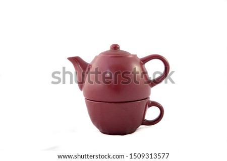 Maroon ceramic teapot on white background. Individual view. Trim. It is divided into two parts because it is an individual teapot that has the glass for tea at the bottom. Two handles are seen
