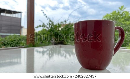 Maroon cup coffee on the table