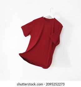 Maroon tshirt with hanger. Flying cotton T-shirt isolated on white background. - Shutterstock ID 2095252273