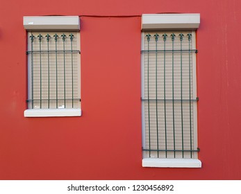 Maroon wall with two windows