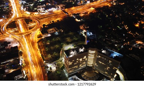  Marousi, Attica / Greece - October 31 2018: Aerial drone bird's eye night high speed shot of public Helenic Telecommunication headquarters known as OTE and ring road at Kifisias avenue