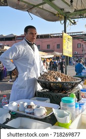 MARRAKECH, MOROCCO - MARCH 15, 2012: Seller of snails in spicy sauce, at a food stall in Jemaa el Fna square, in the tourist center of the city