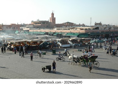 MARRAKESH, MOROCCO - May 30, 2009: A Busy Market With Horses And People In Marrakesh City Square, Morocco