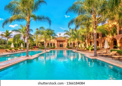 Marrakesh, Morocco - October 19, 2015. Luxury Tourism In Morocco, With A Palace Style Hotel, Lavish Swimming Pool, And Lush Gardens.