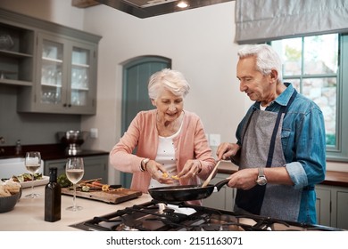 Marriage is all about teamwork. Cropped shot of a senior couple cooking together at home. - Powered by Shutterstock