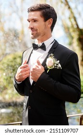 Marriage Life Here I Come. Shot Of A Handsome Young Man Fixing Himself Up And Getting Ready Outdoors On His Wedding Day.