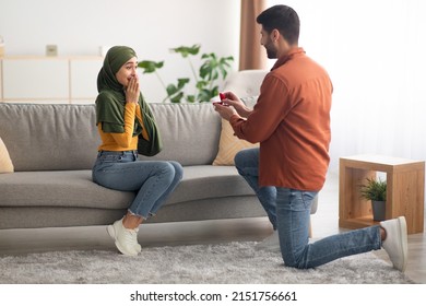 Marriage Proposal. Muslim Man Proposing On One Knee To Woman Offering Box With Engagement Ring At Home. Middle Eastern Boyfriend Asking His Girlfriend To Become His Wife. Love And Relationship - Powered by Shutterstock