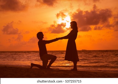 Marriage proposal at sunset beach - Powered by Shutterstock