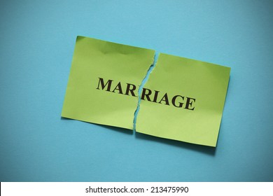 Marriage Rift (broken marriage).Torn of paper with the word "Marriage". Concept Image.