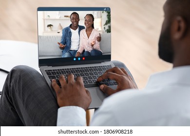 Marriage Therapy Online. Black Counselor Speaking With Happy Couple Via Video Call On Laptop Computer, Over Shoulder View, Selective Focus