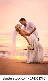 A married couple, bride and groom, at sunset on a beautiful tropical beach